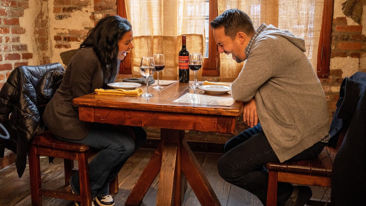 Renee Elise Goldsberry and Lin-Manuel Miranda laugh in a scene from the movie Satisfied. (Photo Credit: Courtesy of AURA Entertainment.)