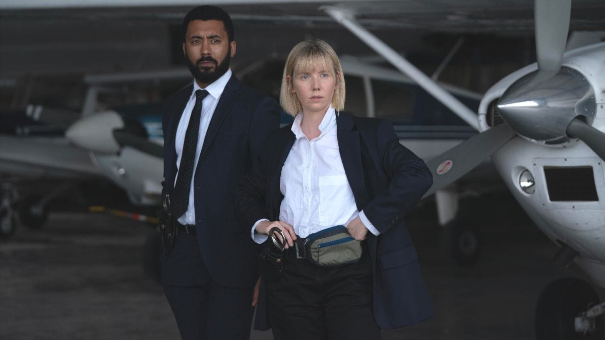 Zach Wyatt as Phil Parhatka and Lauren Lyle as Karen Pirie in Karen Pirie season 2. (Photo Credit: Courtesy of BritBox.)