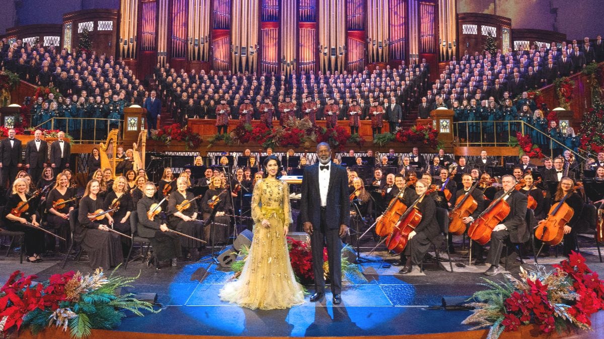 Actors Ruthie Ann Miles and Dennis Haysbert on stage with the Tabernacle Choir and Orchestra at Temple Square. (Photo Credit: Courtesy of Intellectual Reserve, Inc.)