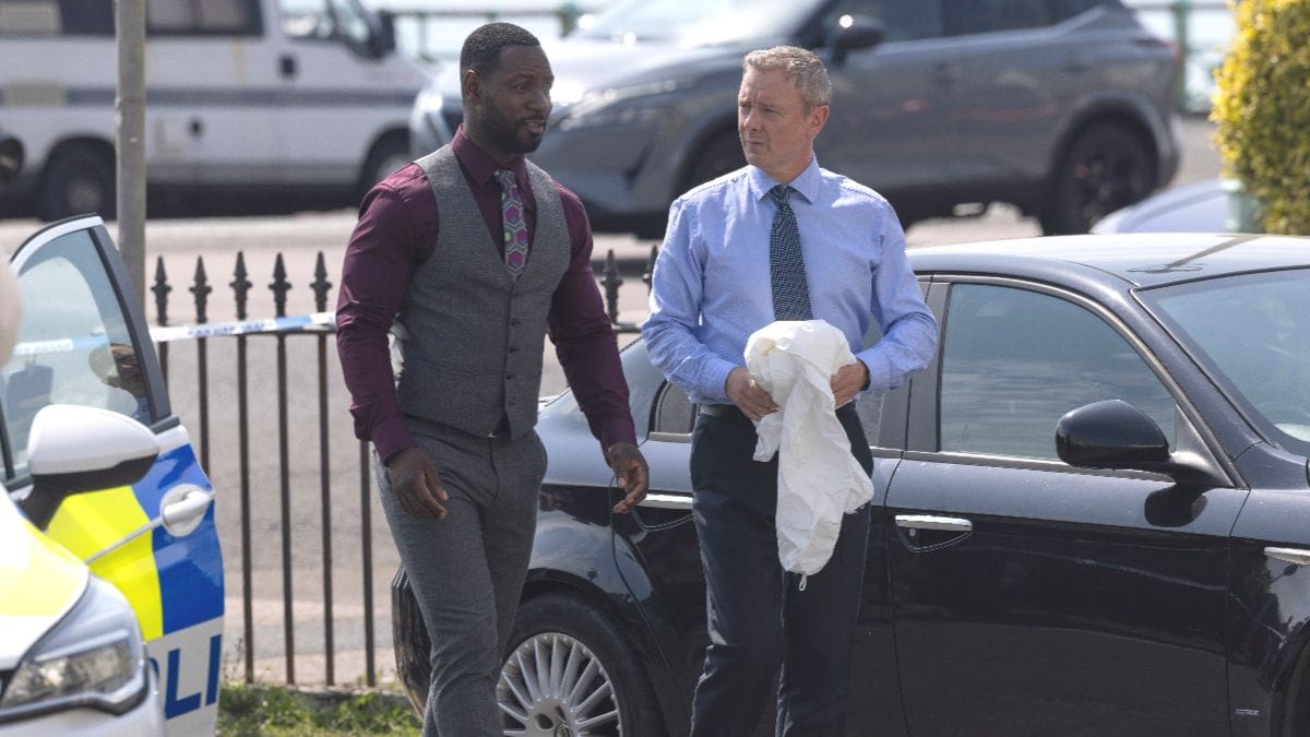 Actor Richie Campbell as Glenn Branson and actor John Simm as Roy Grace in Grace season 5, episode 3. (Photo Credit: Courtesy of BritBox.)