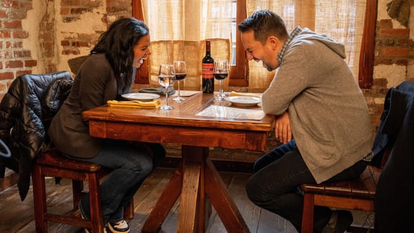 Renee Elise Goldsberry and Lin-Manuel Miranda laugh in a scene from the movie Satisfied. (Photo Credit: Courtesy of AURA Entertainment.)