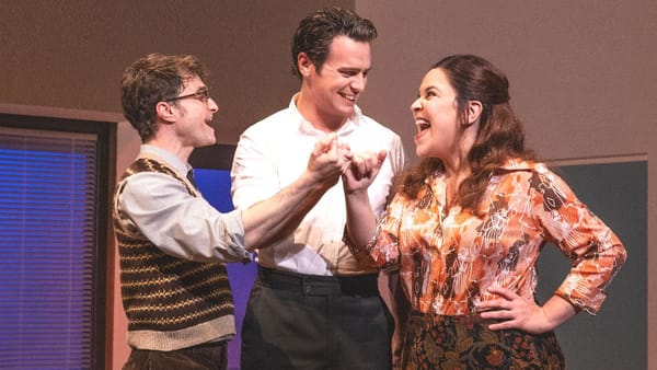 Daniel Radcliffe as Charley Kringas, Jonathan Groff as Franklin Shepard and Lindsay Mendez as Mary Flynn in Merrily We Roll Along. (Photo Credit: Courtesy of Fathom Entertainment.)