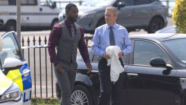 Actor Richie Campbell as Glenn Branson and actor John Simm as Roy Grace in Grace season 5, episode 3. (Photo Credit: Courtesy of BritBox.)